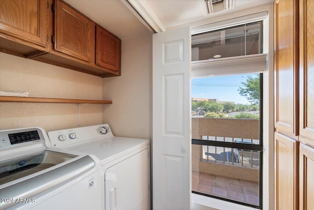 laundry area with cabinets and washing machine and clothes dryer