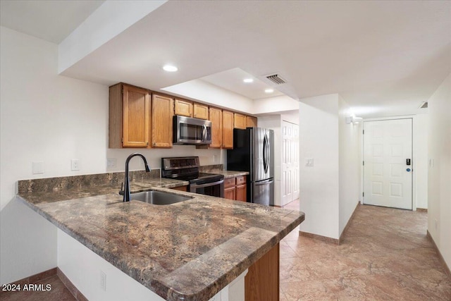 kitchen featuring kitchen peninsula, sink, and appliances with stainless steel finishes