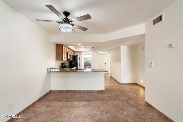 kitchen featuring ceiling fan, kitchen peninsula, and appliances with stainless steel finishes