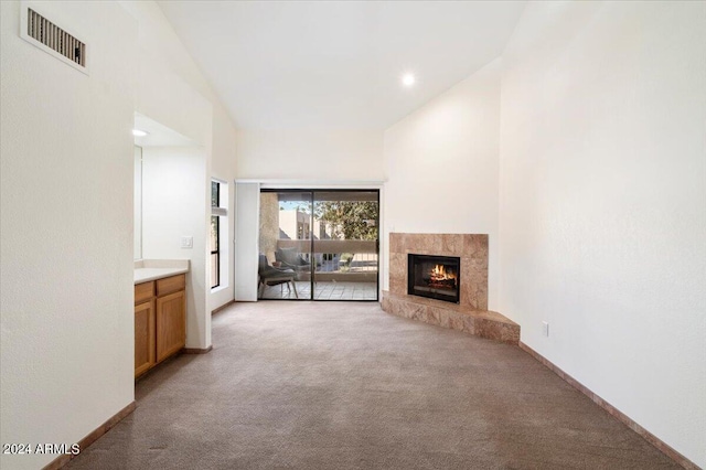 unfurnished living room featuring a high end fireplace and light carpet