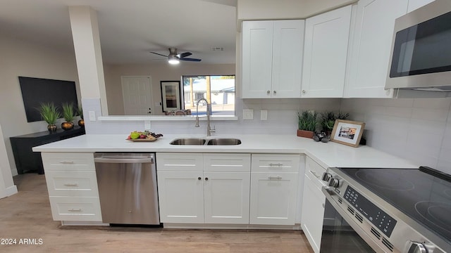 kitchen featuring ceiling fan, white cabinetry, sink, and appliances with stainless steel finishes