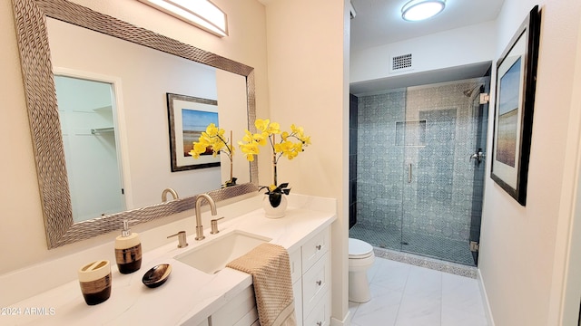 bathroom with vanity, an enclosed shower, and toilet