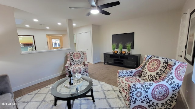 living room featuring ceiling fan and light wood-type flooring