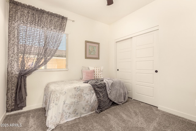 carpeted bedroom with a closet and ceiling fan