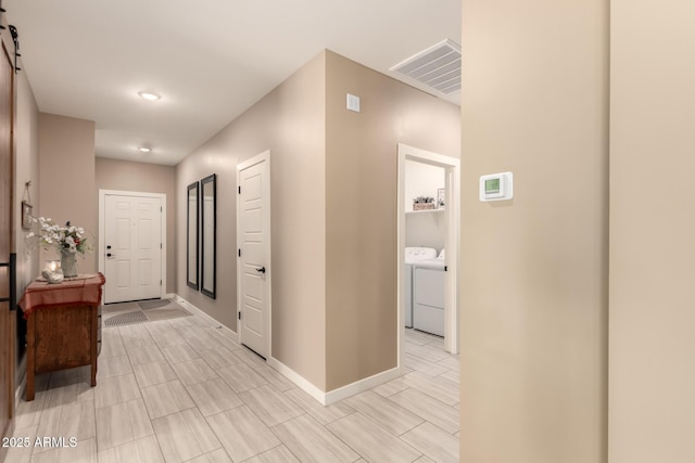 corridor featuring washer and clothes dryer