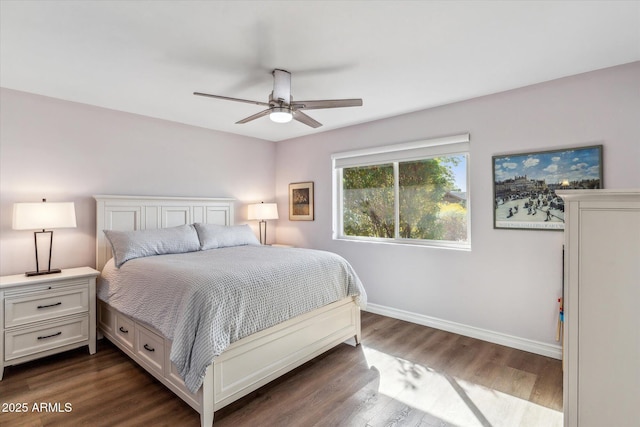 bedroom featuring ceiling fan, dark wood-type flooring, and baseboards