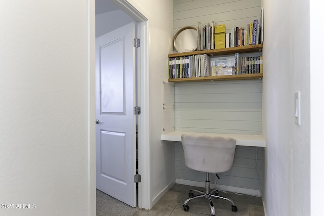 tiled office space with built in study area and wood walls