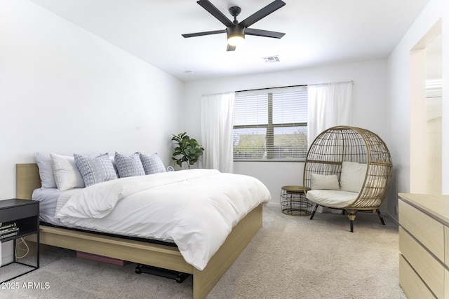 bedroom with a ceiling fan, light carpet, and visible vents