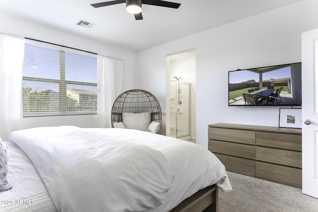 carpeted bedroom featuring visible vents, ceiling fan, and ensuite bathroom