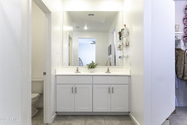 full bathroom featuring tile patterned flooring, toilet, a sink, visible vents, and double vanity