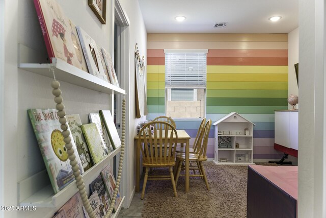 office area featuring wood walls, carpet, and visible vents