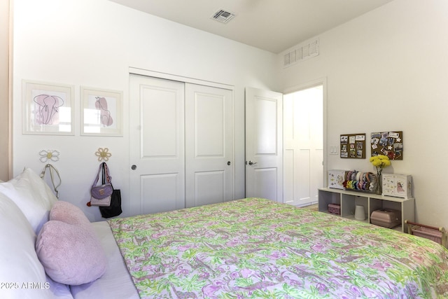 bedroom with a closet and visible vents