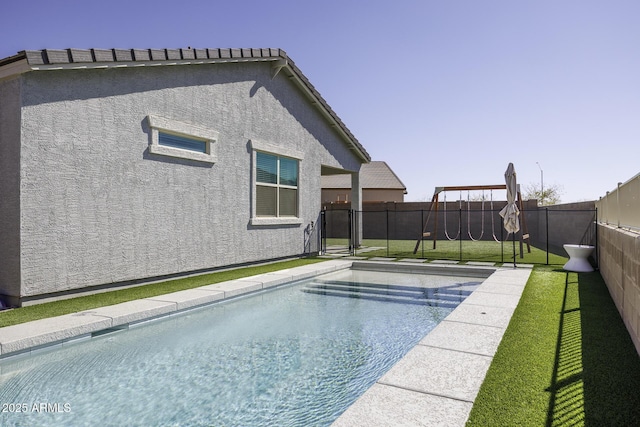 view of swimming pool featuring a fenced in pool, a fenced backyard, and a yard