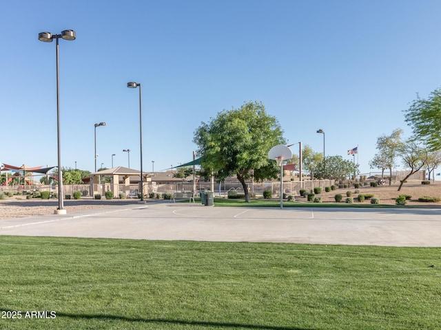 view of sport court with a yard, fence, and community basketball court