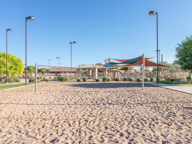 surrounding community with fence and volleyball court