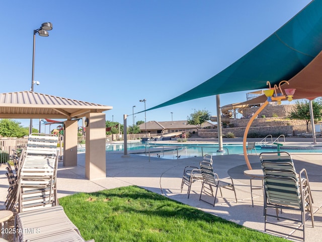 pool featuring fence and a patio