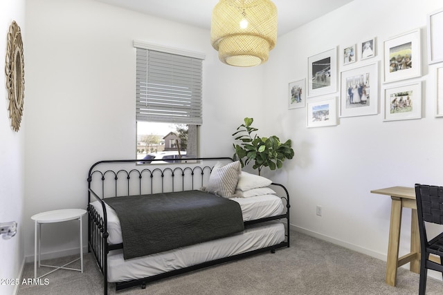 carpeted bedroom featuring baseboards