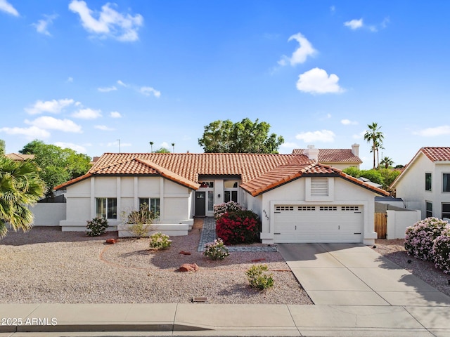 6145 E Snowdon St, Mesa, AZ 85215 - mediterranean / spanish home featuring stucco siding, a tiled roof, a garage, and driveway