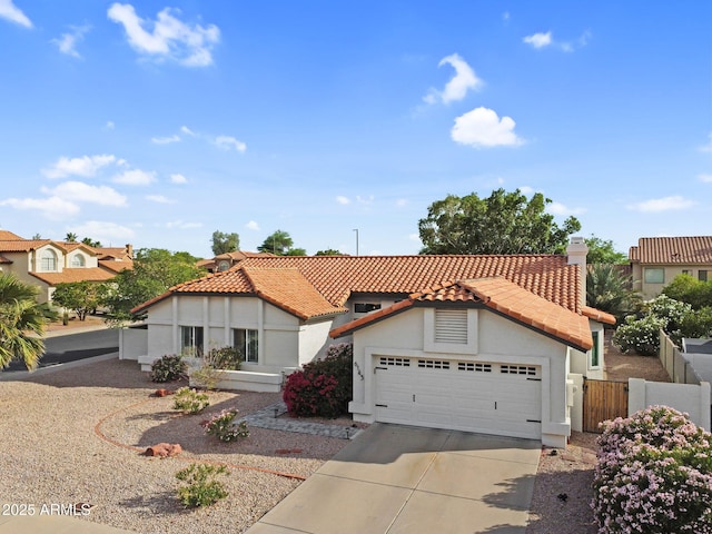6145 E Snowdon St, Mesa, AZ 85215 - mediterranean / spanish home with stucco siding, a tile roof, an attached garage, and concrete driveway