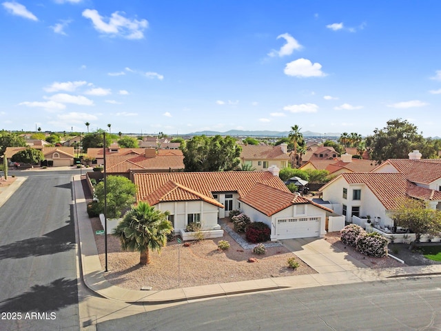 6145 E Snowdon St, Mesa, AZ 85215 - view of front facade featuring a residential view, a garage, driveway, and stucco siding