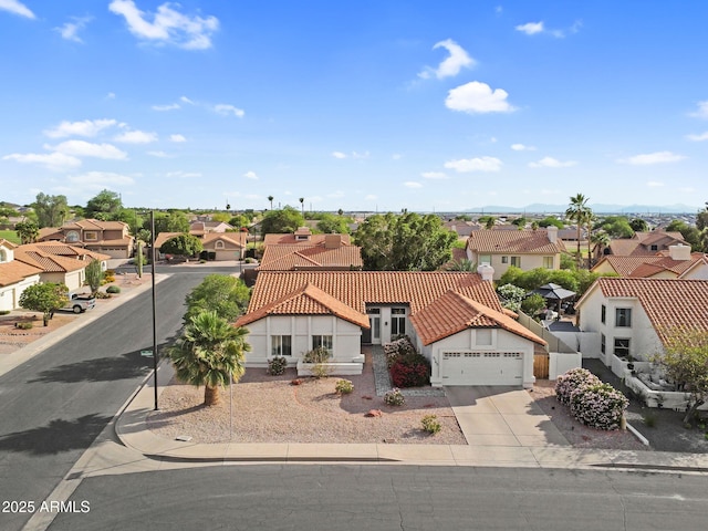 6145 E Snowdon St, Mesa, AZ 85215 - view of front of house featuring a residential view, concrete driveway, a tiled roof, and stucco siding