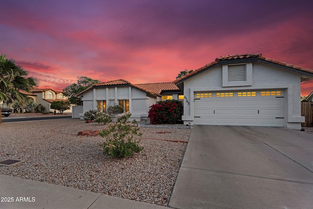 6145 E Snowdon St, Mesa, AZ 85215 - view of front of property featuring a garage, driveway, a tiled roof, and stucco siding