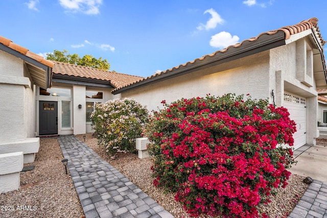 6145 E Snowdon St, Mesa, AZ 85215 - view of side of home with stucco siding, an attached garage, a tile roof, and driveway