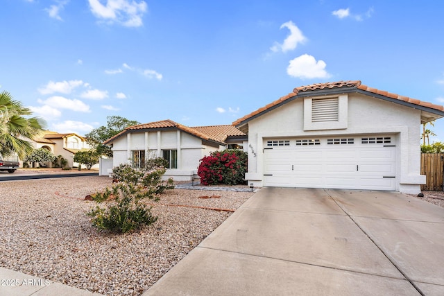 6145 E Snowdon St, Mesa, AZ 85215 - mediterranean / spanish-style house featuring driveway, a tile roof, stucco siding, and an attached garage