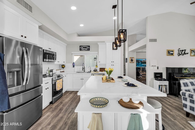 6145 E Snowdon St, Mesa, AZ 85215 - kitchen with stainless steel appliances, a center island, a sink, dark wood-style flooring, and white cabinetry