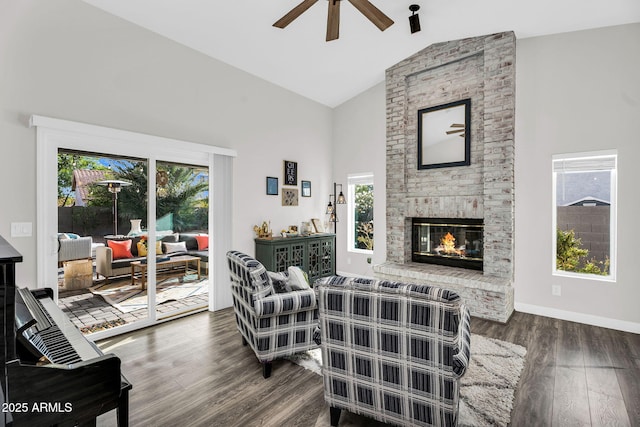 6145 E Snowdon St, Mesa, AZ 85215 - living room featuring high vaulted ceiling, a ceiling fan, wood finished floors, a brick fireplace, and baseboards