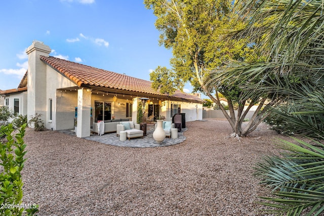 6145 E Snowdon St, Mesa, AZ 85215 - rear view of house featuring stucco siding, a tile roof, outdoor lounge area, a patio area, and a chimney