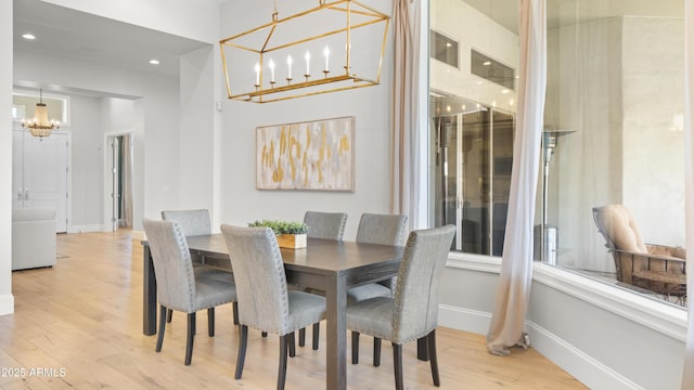 dining area with a chandelier and light hardwood / wood-style floors