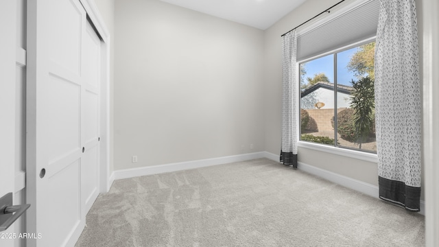 unfurnished bedroom with light carpet and a closet