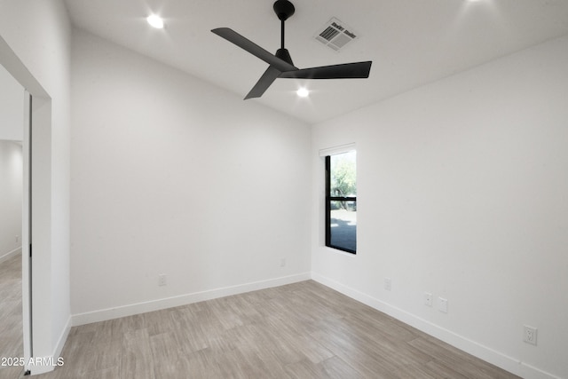 unfurnished room with ceiling fan, light hardwood / wood-style floors, and lofted ceiling