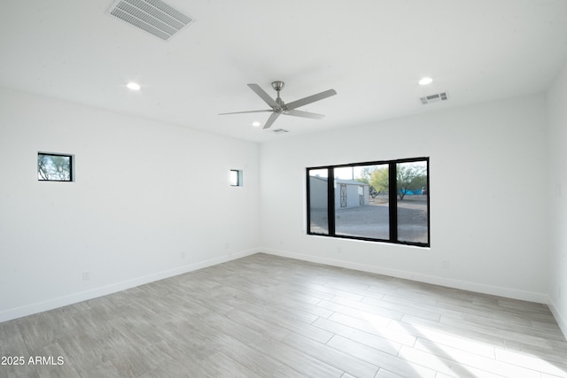 unfurnished room with ceiling fan and light wood-type flooring