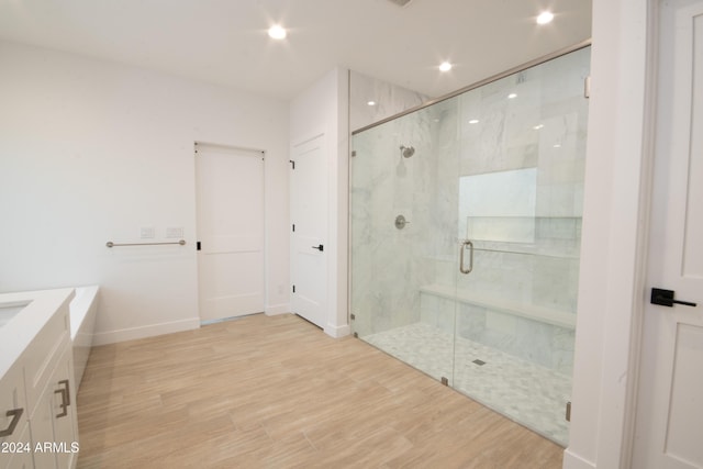 bathroom featuring hardwood / wood-style flooring and an enclosed shower