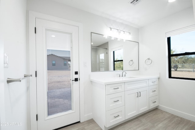 bathroom with vanity and hardwood / wood-style flooring