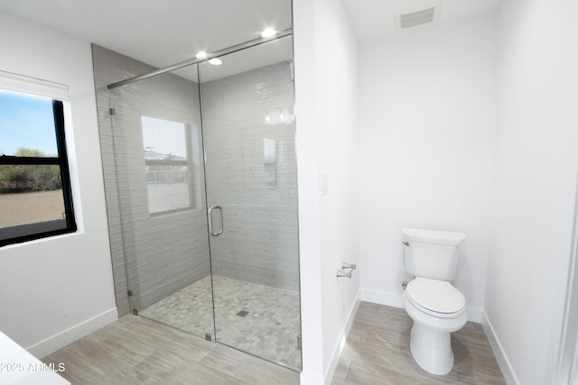 bathroom featuring toilet and walk in shower