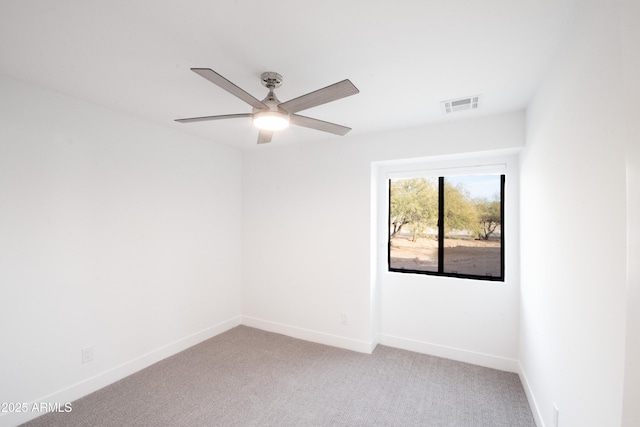 carpeted spare room with ceiling fan