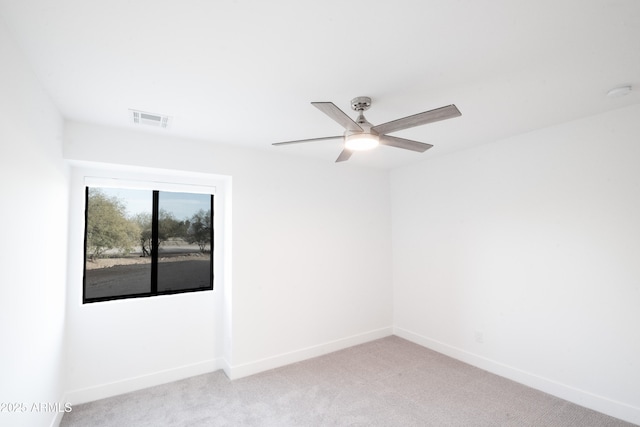 unfurnished room with light colored carpet and ceiling fan