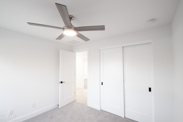 unfurnished bedroom with light carpet, a closet, and ceiling fan