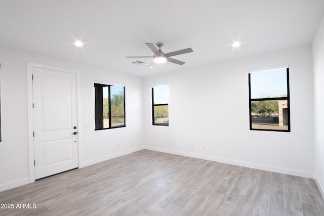 unfurnished room with ceiling fan and light hardwood / wood-style floors