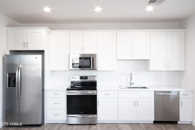 kitchen with white cabinets, stainless steel appliances, and sink