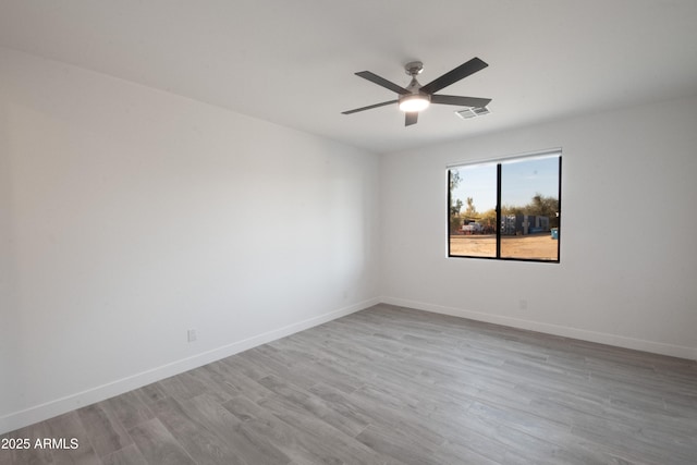 spare room with ceiling fan and light hardwood / wood-style floors