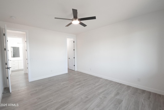 empty room featuring ceiling fan and light wood-type flooring