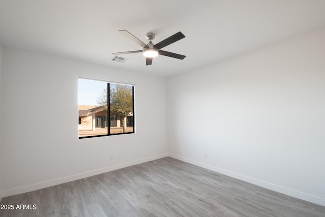 empty room featuring ceiling fan and light hardwood / wood-style flooring