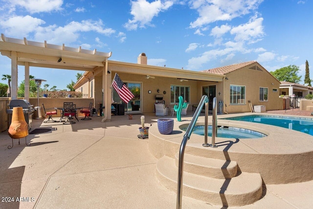 view of pool featuring an in ground hot tub and a patio