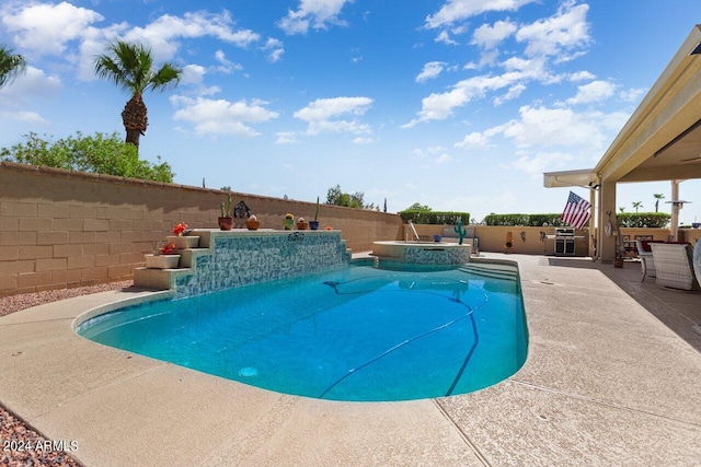 view of swimming pool with an in ground hot tub and a patio area