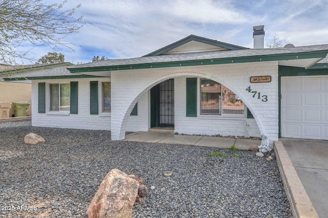 view of exterior entry with a garage