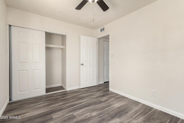 3114 W Villa Maria Dr, Phoenix, AZ 85053 - unfurnished bedroom featuring dark wood-type flooring, a closet, and a ceiling fan